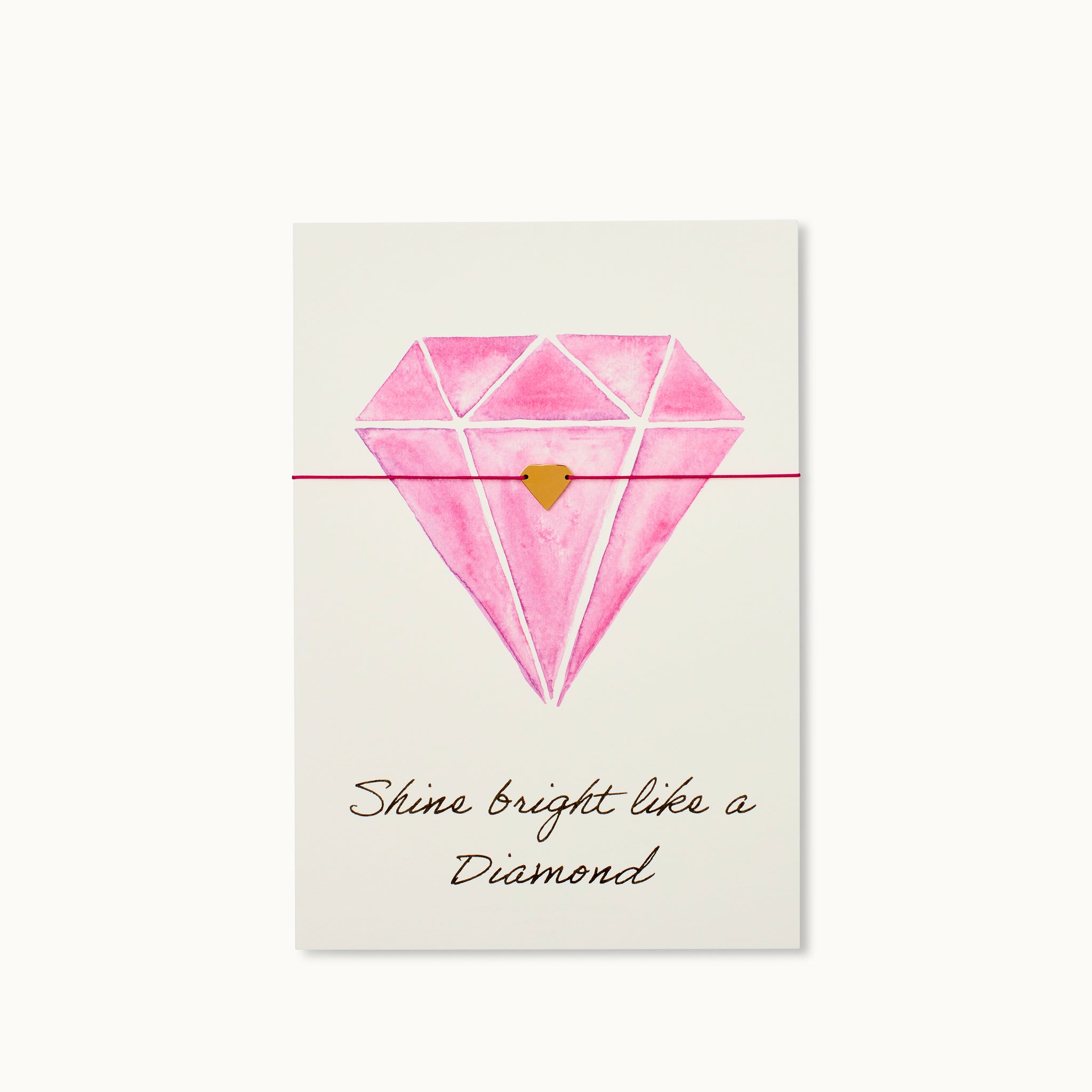 Shine bright like a Diamond! Karte mit einem Diamanten als 18K vergoldeter Anhänger an einem fuchsiafarbenen farbigen Armband. 