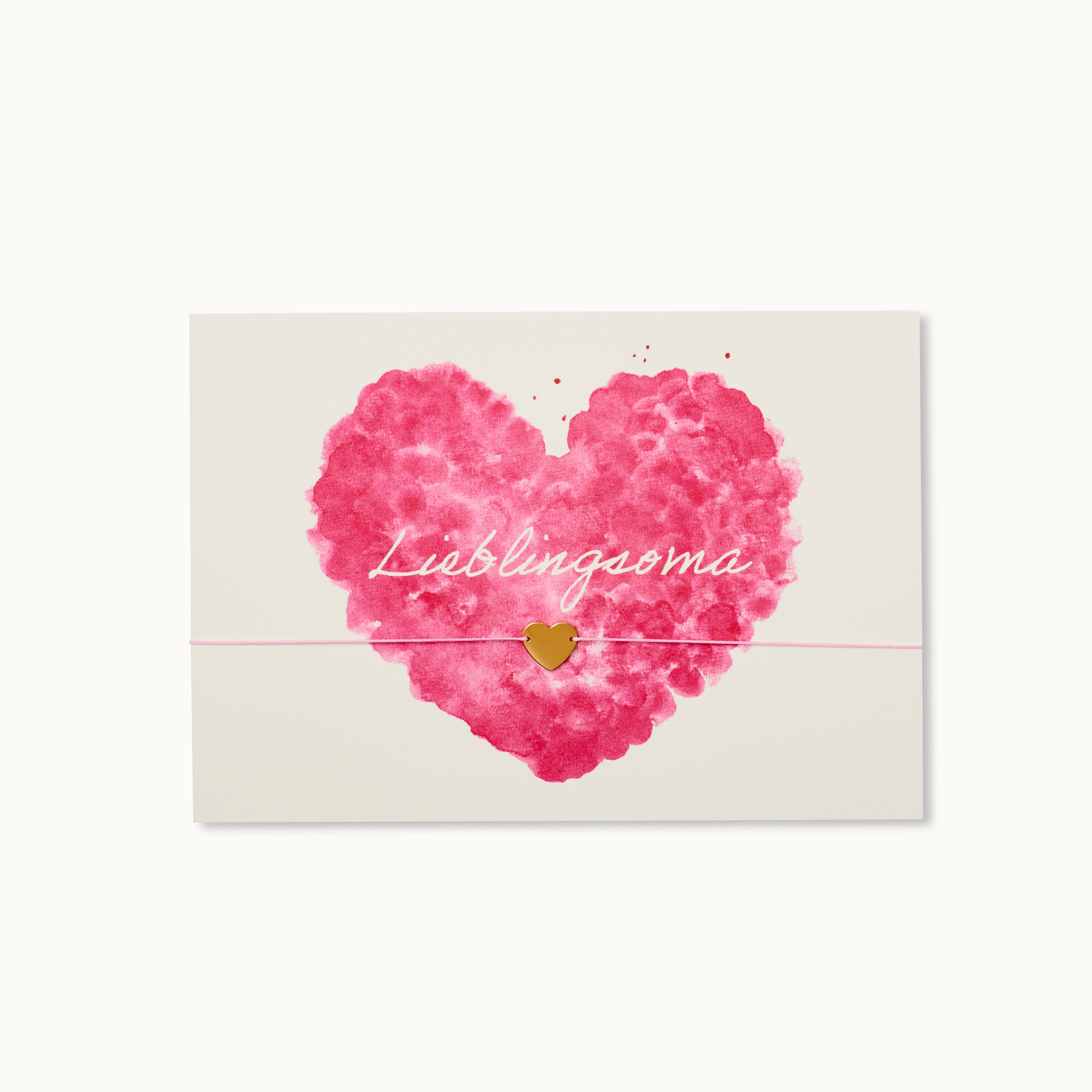 Die perfekte Karte für jede Lieblingsoma mit einem Herz als 18K vergoldeter Anhänger an einem rosafarbenen Armband für jede Lieblingsoma. 