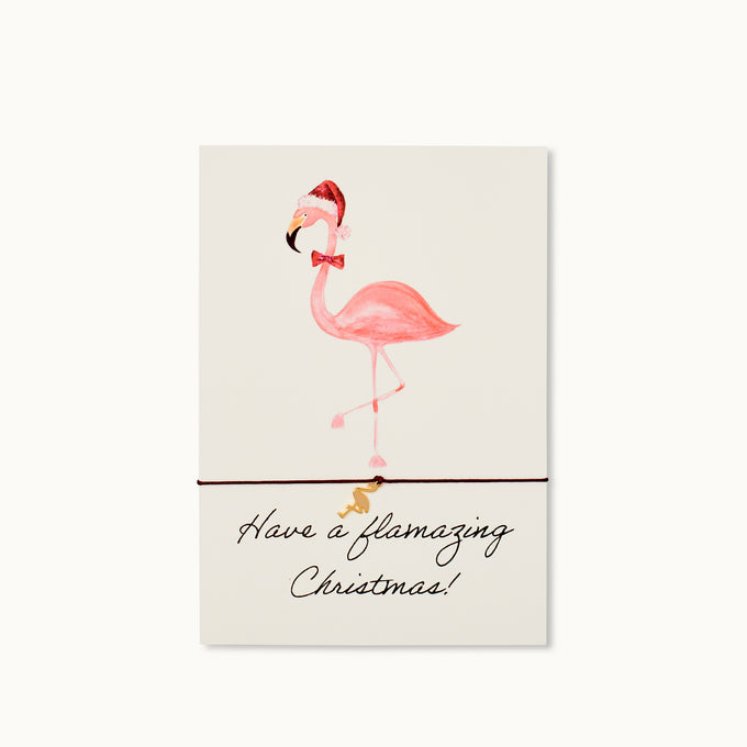 Have a flamazing Christmas! Karte mit einem Flamingo als 18K vergoldeter Anhänger an einem purpurrotem Armband.