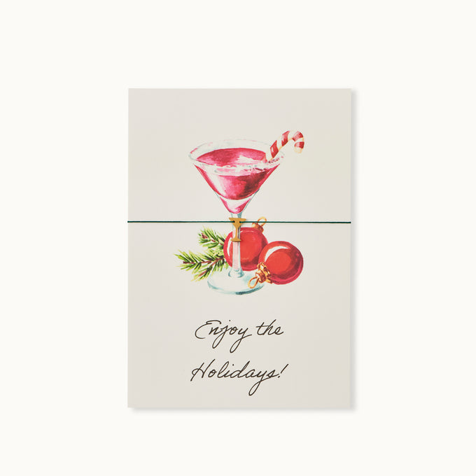 Enjoy the holidays! Karte mit einem Martiniglas als 18K vergoldeter Anhänger an einem dunkelgrünen Armband. 