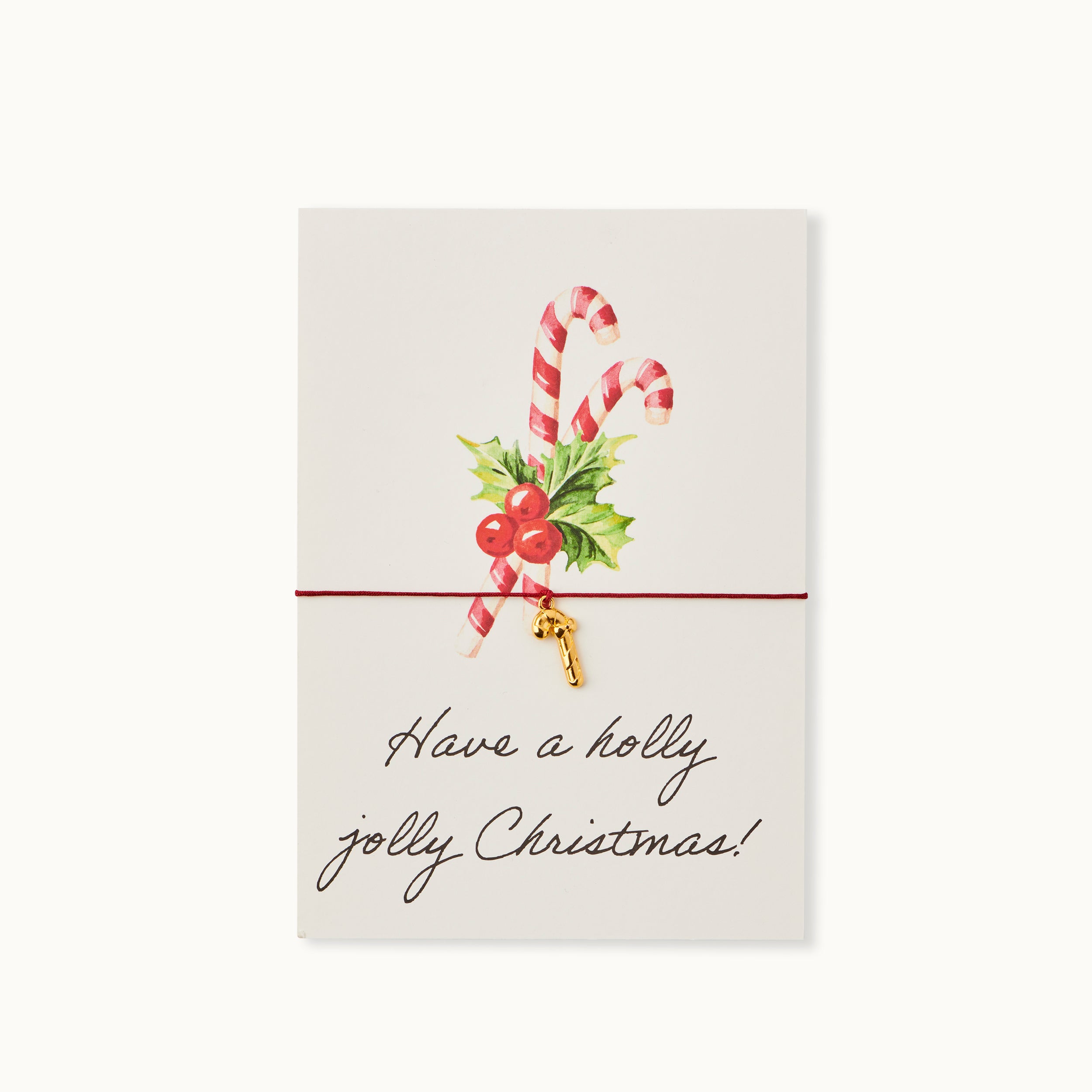 Have a holly jolly Christmas! Karte mit einer Zuckerstange als 18K vergoldeter Anhänger an einem dunkelgrünen Armband.